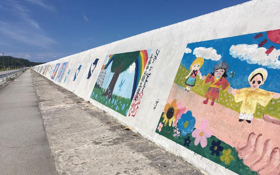 984-foot seawall featuring a number of colorful paintings